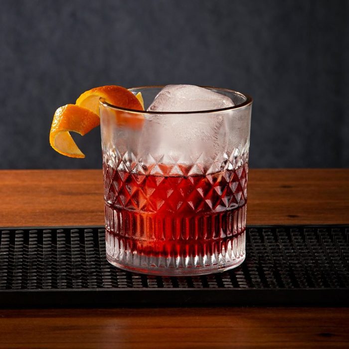 Red cocktail in a glass on a table