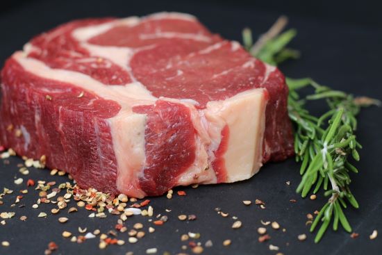 Raw steak on a chopping board